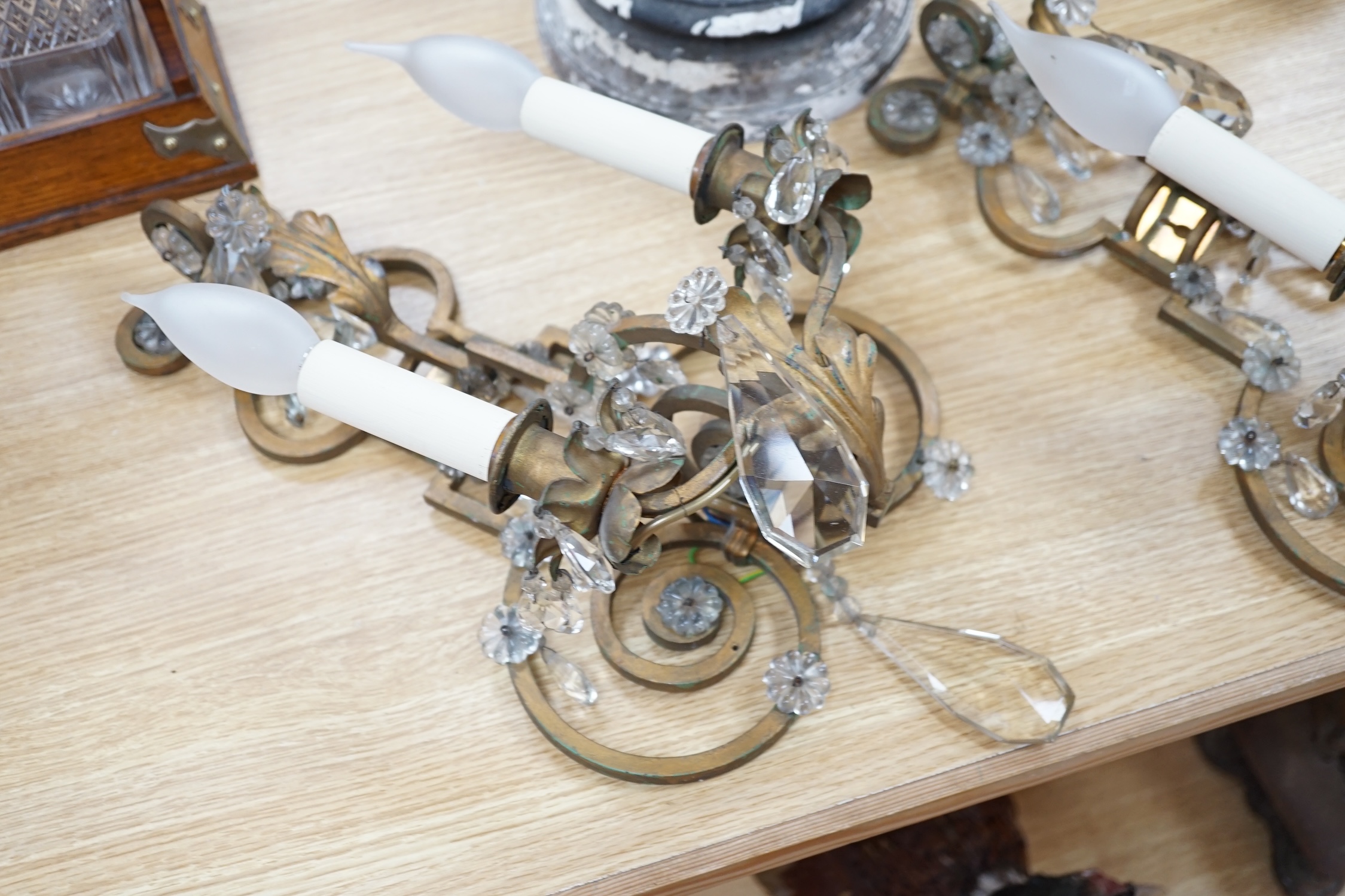 A pair of two branch gilt painted metal wall lights with lustre drops, approximately 44cm high. Condition - fair to good